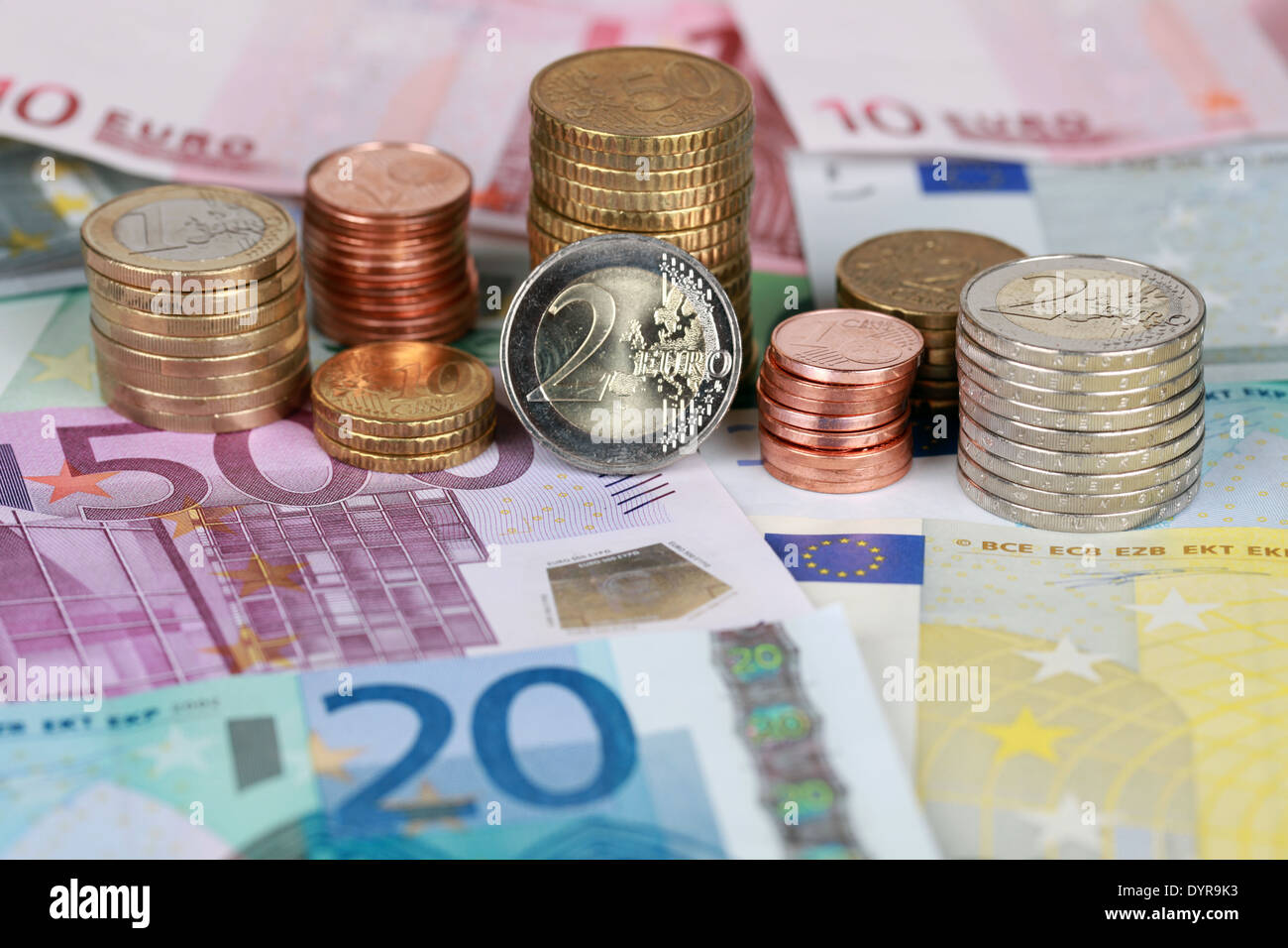 Euro coins on Euro banknotes forming a money background Stock Photo