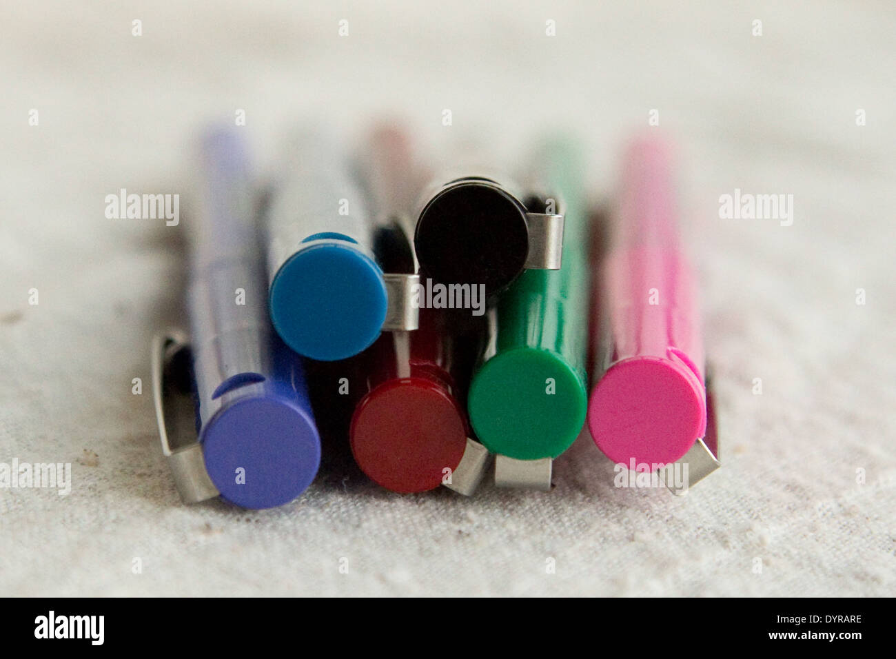 colorful pens with clips stacked on top of each other Stock Photo