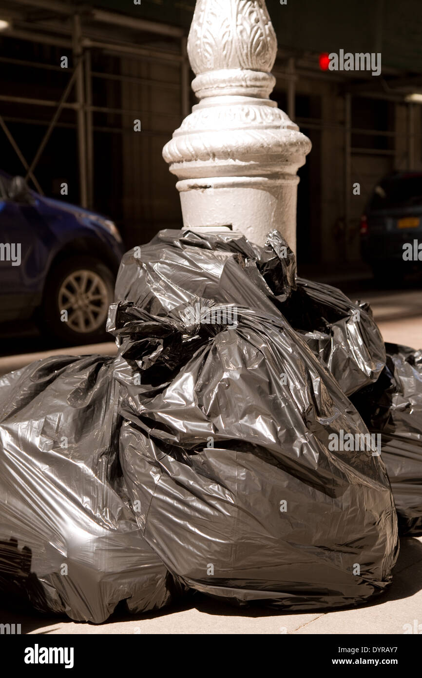 Bags of trash on a New York CIty sidewalk Stock Photo