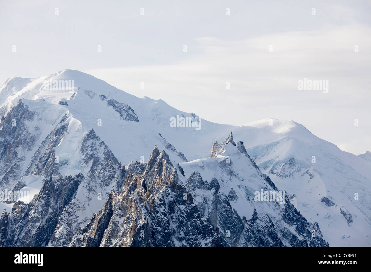 The Aiguille Du Midi gondola station (R), with Mont Blanc mountain in the background (C), seen from the top of Grand Montets. Stock Photo