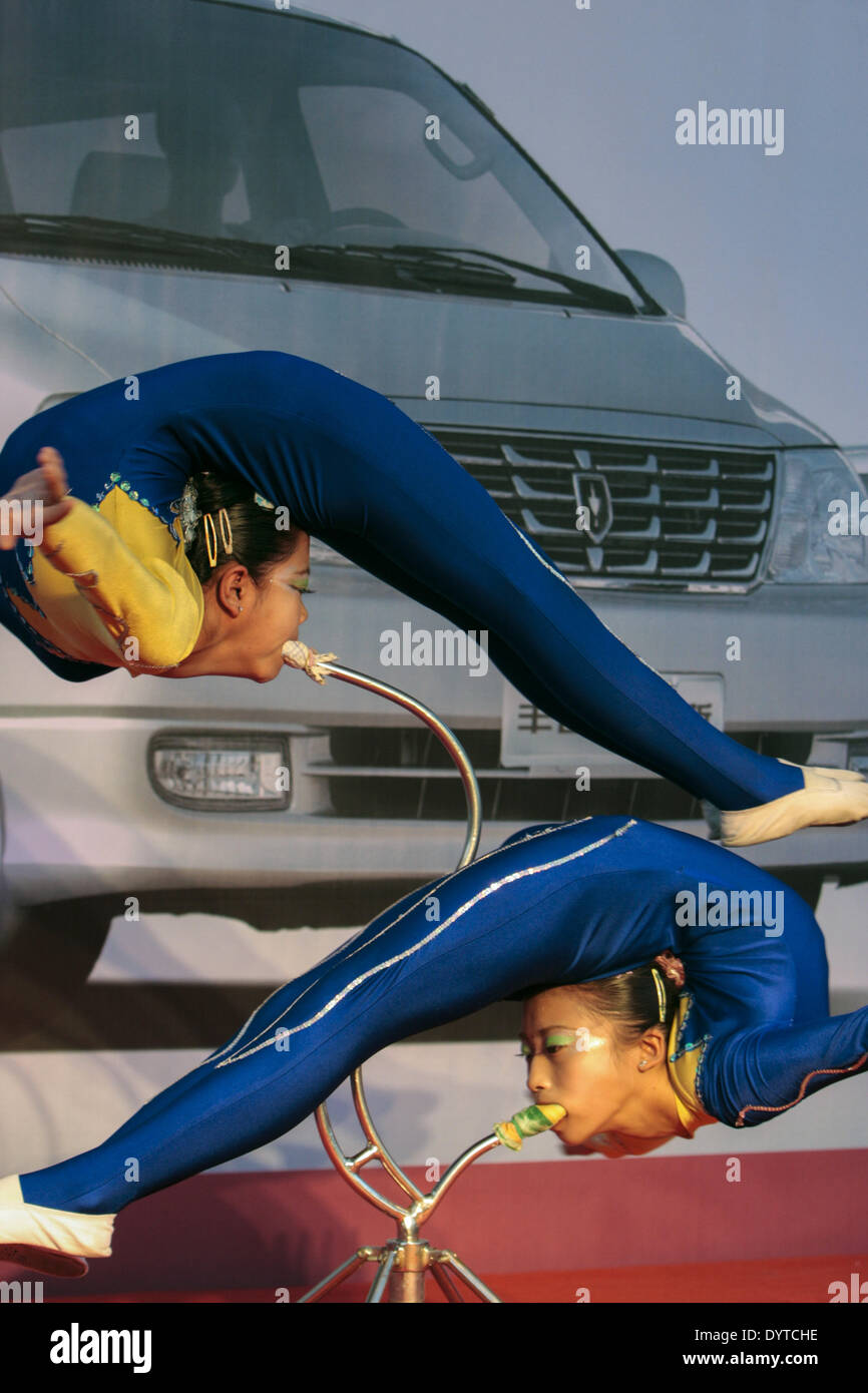Young acrobats perform at a show promoting Brilliance Auto on a street in Shanghai on 14 Oct 07 Stock Photo