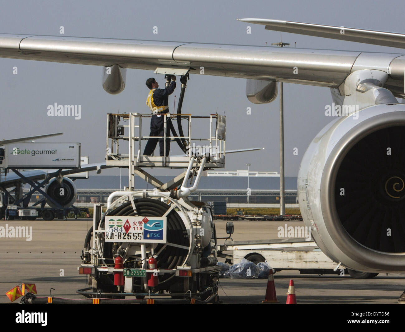 Airport technician fill up gas for a plane at Shanghai Pudong International Airport on 22 Nov 2007 Stock Photo