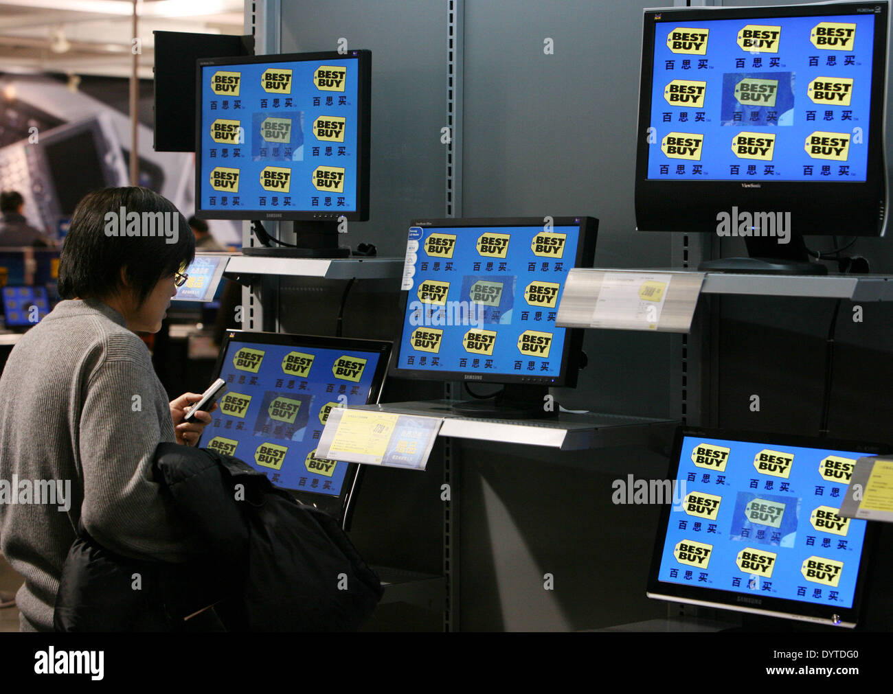 A Customer Looks At Flat Panel Tv Display Inside A Best Buy Store