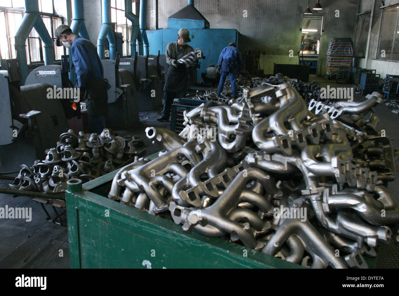Chinese workers polished the engine part at a production line of Minivan of Hafei Automobile Manufacturing Co.Ltd. Stock Photo