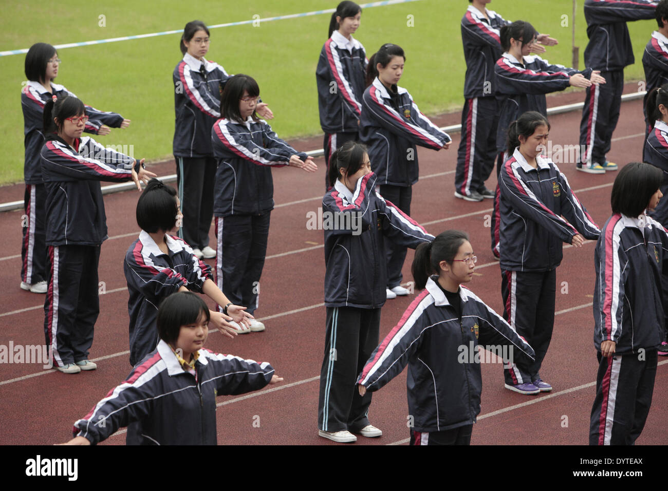 A student yawns during morning exercise at Fuxing Secondong school in Shanghai on 8 Nov 2011 Stock Photo