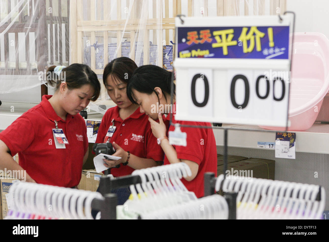 A Chinese worker prepares for the official opening of Wal Mart in Shanghai Stock Photo