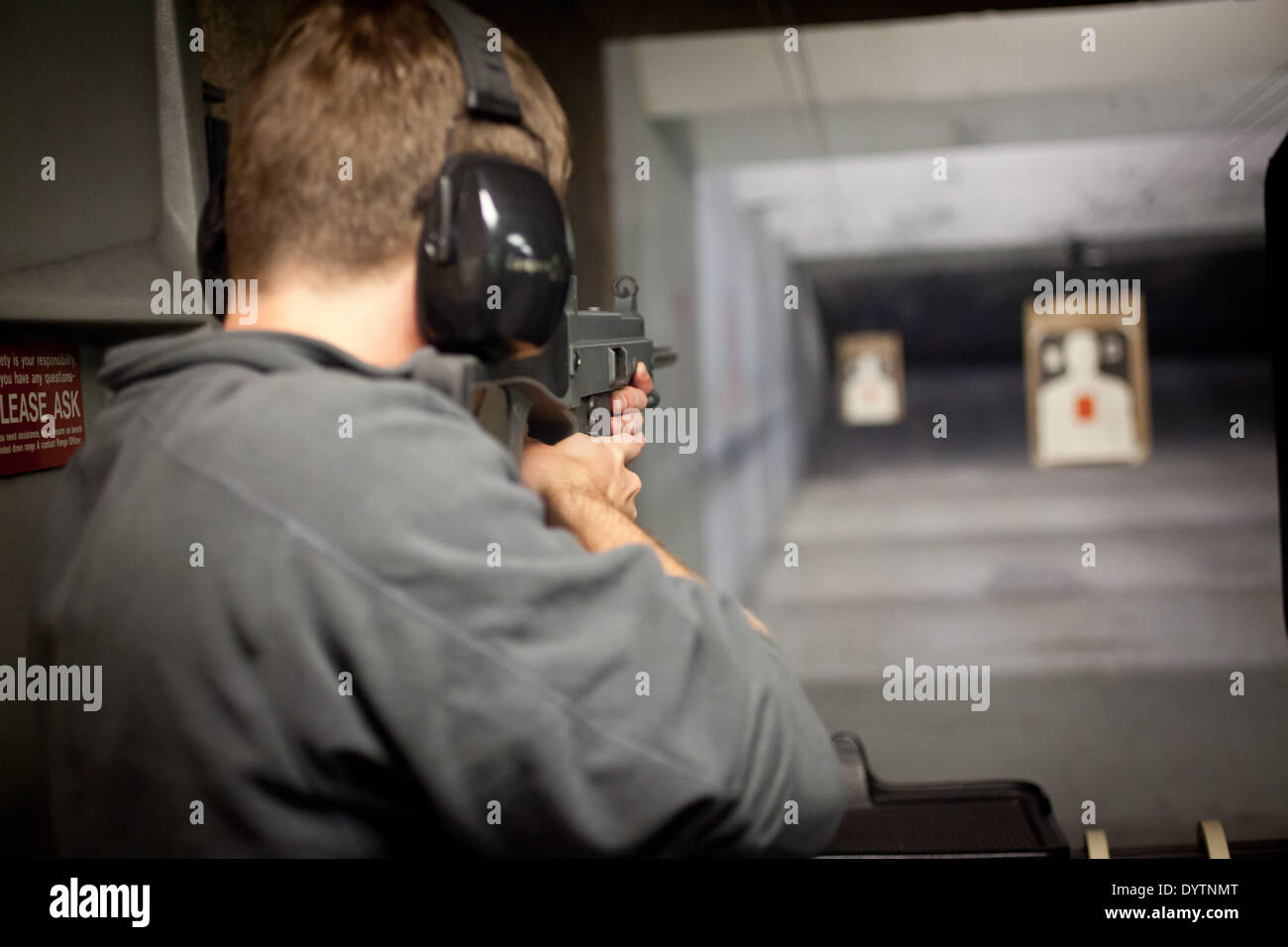 Man at a shooting range aiming at targets with a rifle made by the German defense manufacturing company Heckler & Koch, in April 2013. Stock Photo