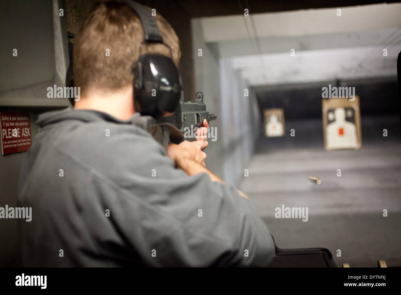Man at a shooting range shooting at targets with a rifle made by the German defense manufacturing company Heckler & Koch, in April 2013. Stock Photo