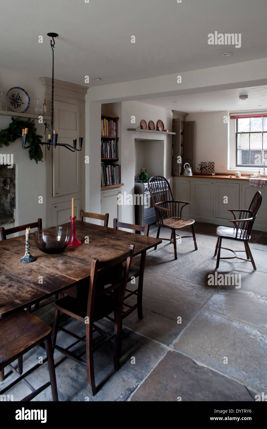 Basement kitchen with dining table and chairs, Whitechapel, London Stock Photo