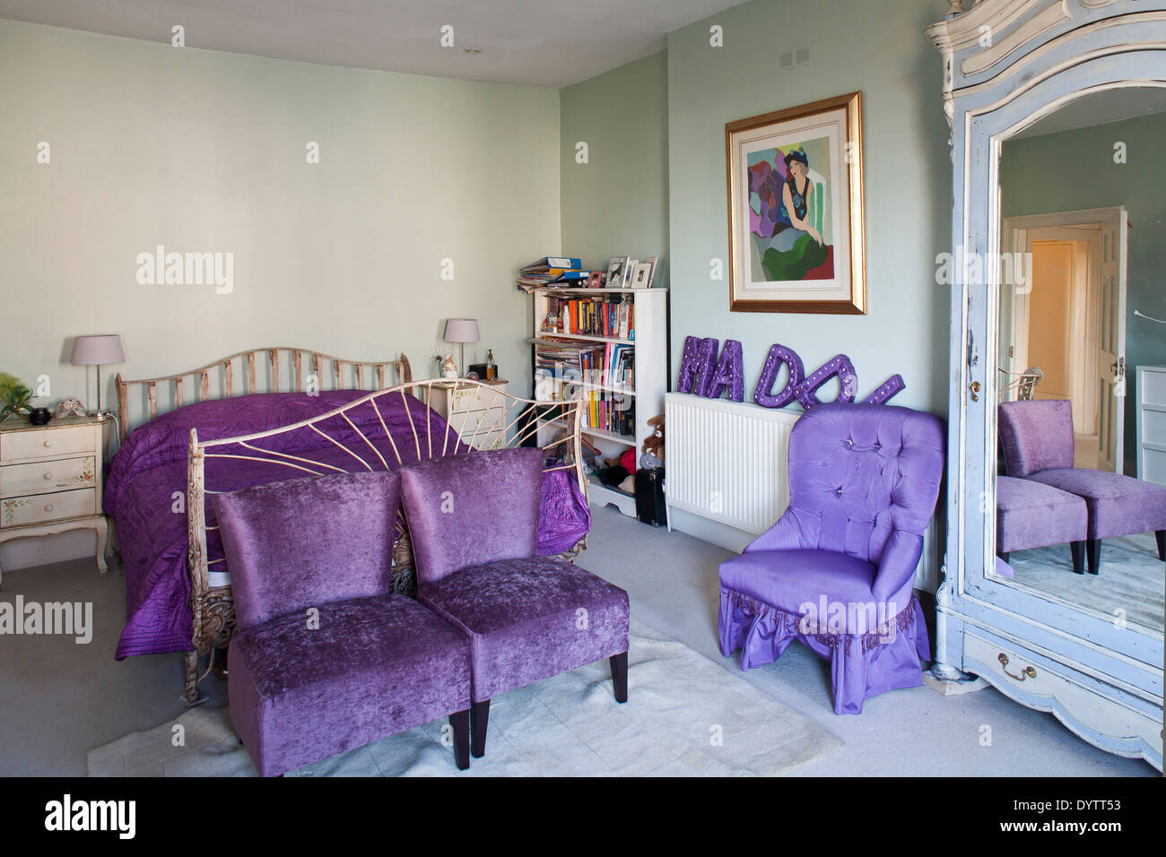 Wrought iron bed in traditional style bedroom with vibrant purple
