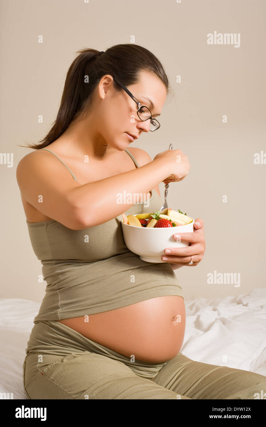 Expectant mother with a bowl of fruit Stock Photo