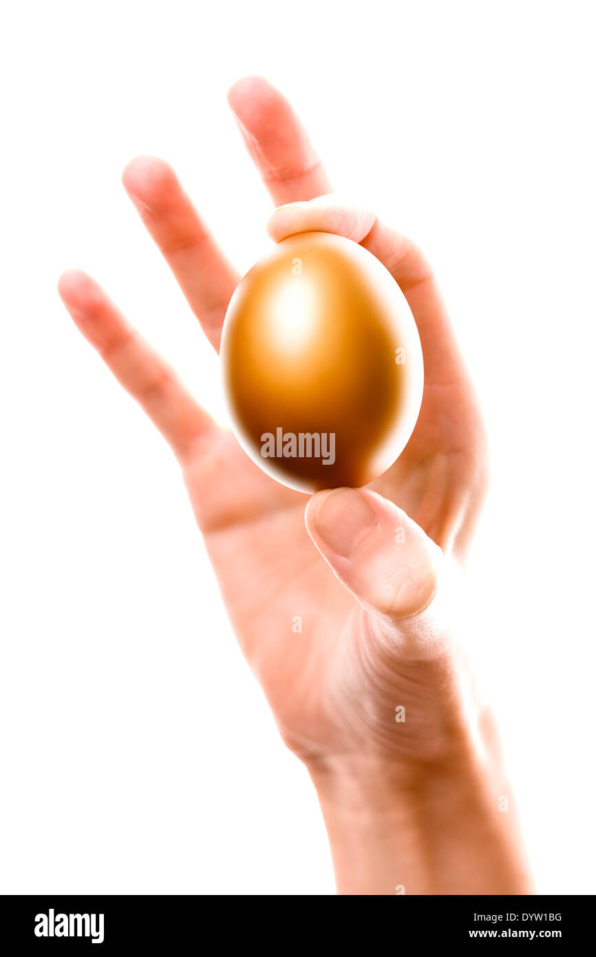 Handing holding a golden egg Stock Photo