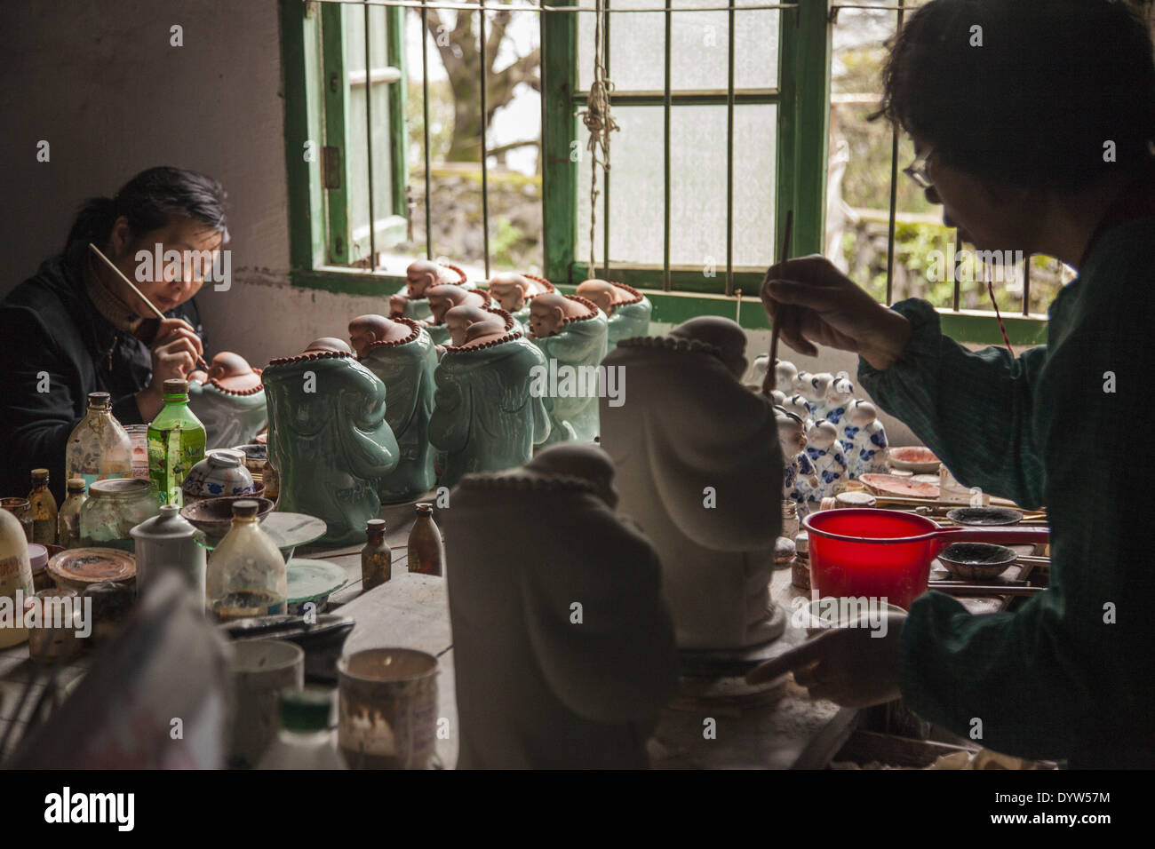 Workers paint porcelain figurine at a in this "Porcelain
