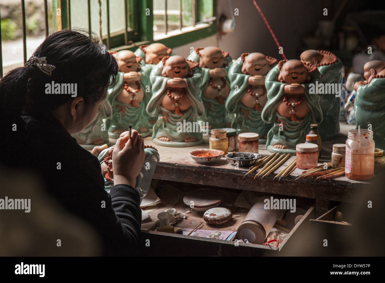 Workers paint porcelain figurine at a in this "Porcelain