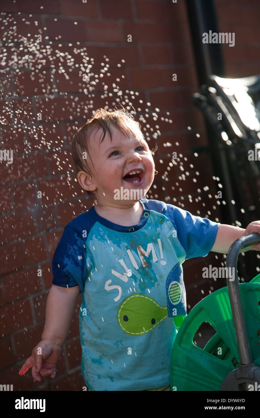 Thomas, Toddler, 13 months old playing with water Stock Photo