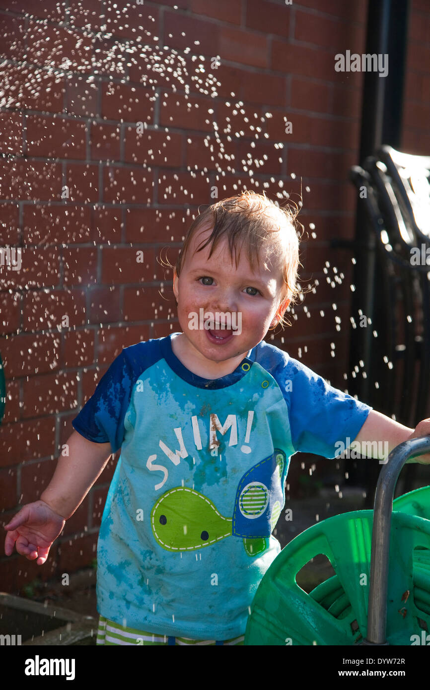 Toddler, 13 months old playing with water Stock Photo