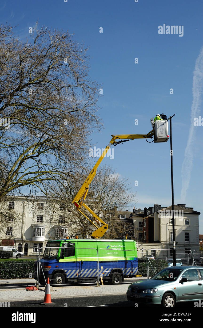 man in cherry picker fixing street light Stock Photo Alamy