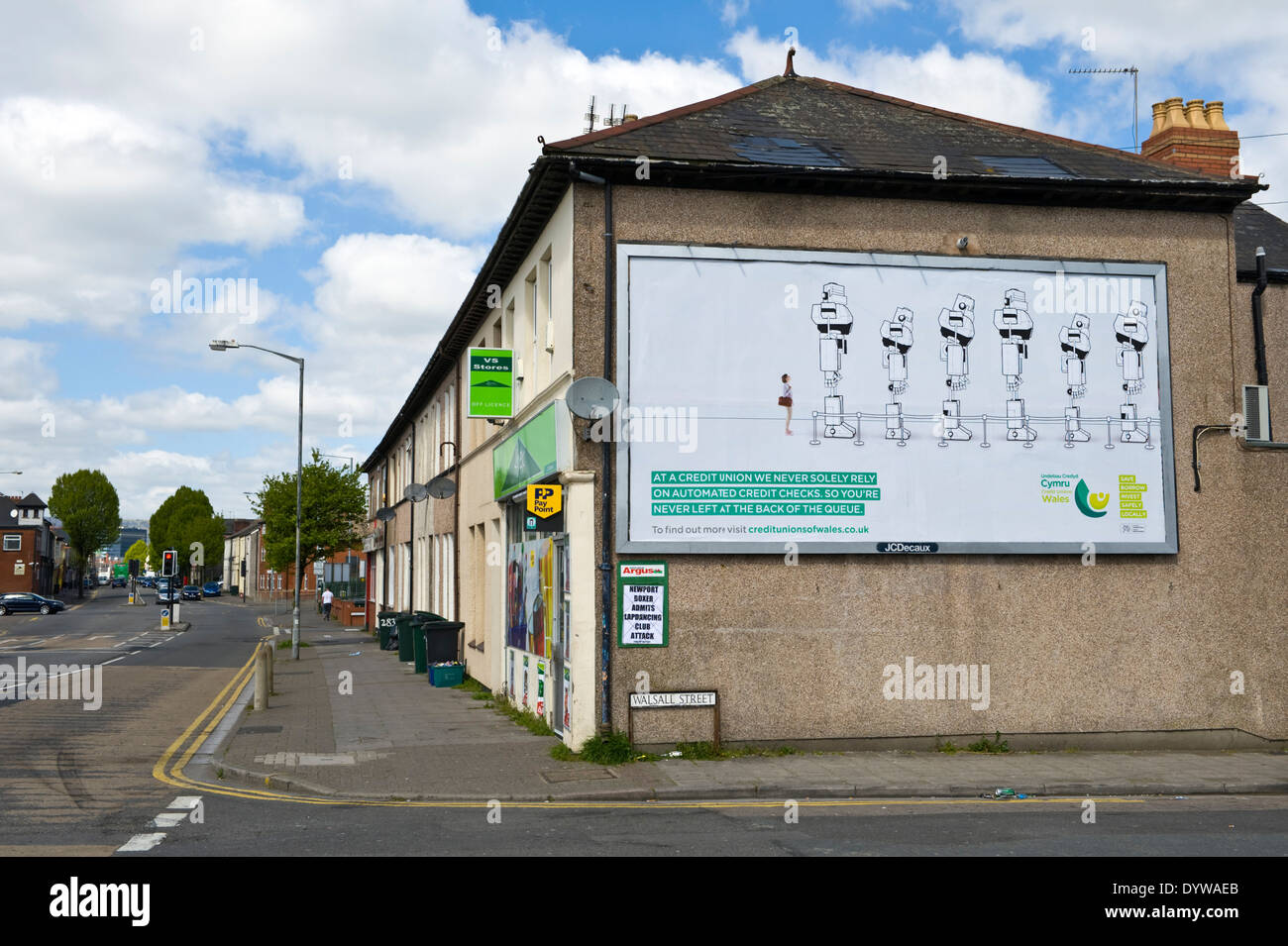 Wales Credit Unions advertising billboard on end wall of corner shop JCDecaux site in Newport South Wales UK Stock Photo