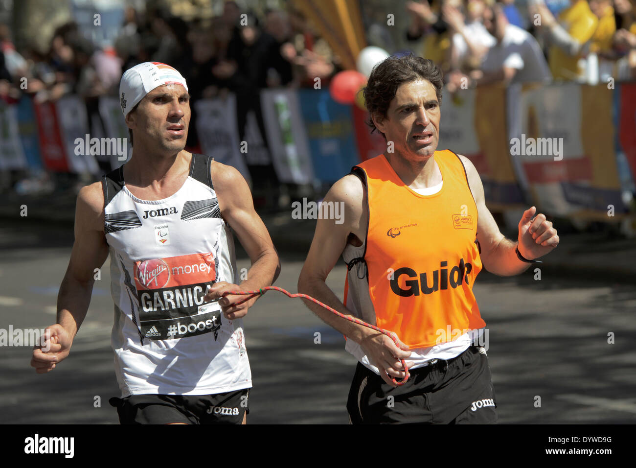 Disabled athlete with a guide at London Marathon Stock Photo