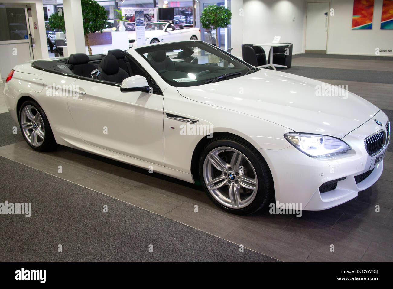Brand new White BMW 6 Series M Sport Convertible 2 door 640d with roof down in car showroom Stock Photo