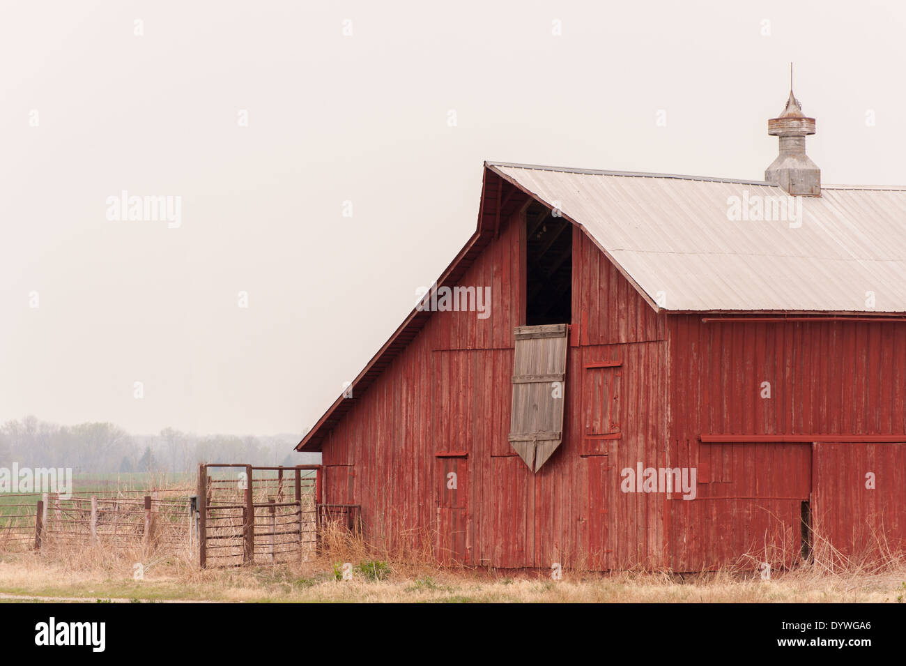 Old red barn on the prairie on a cloudy day with copy space Stock Photo