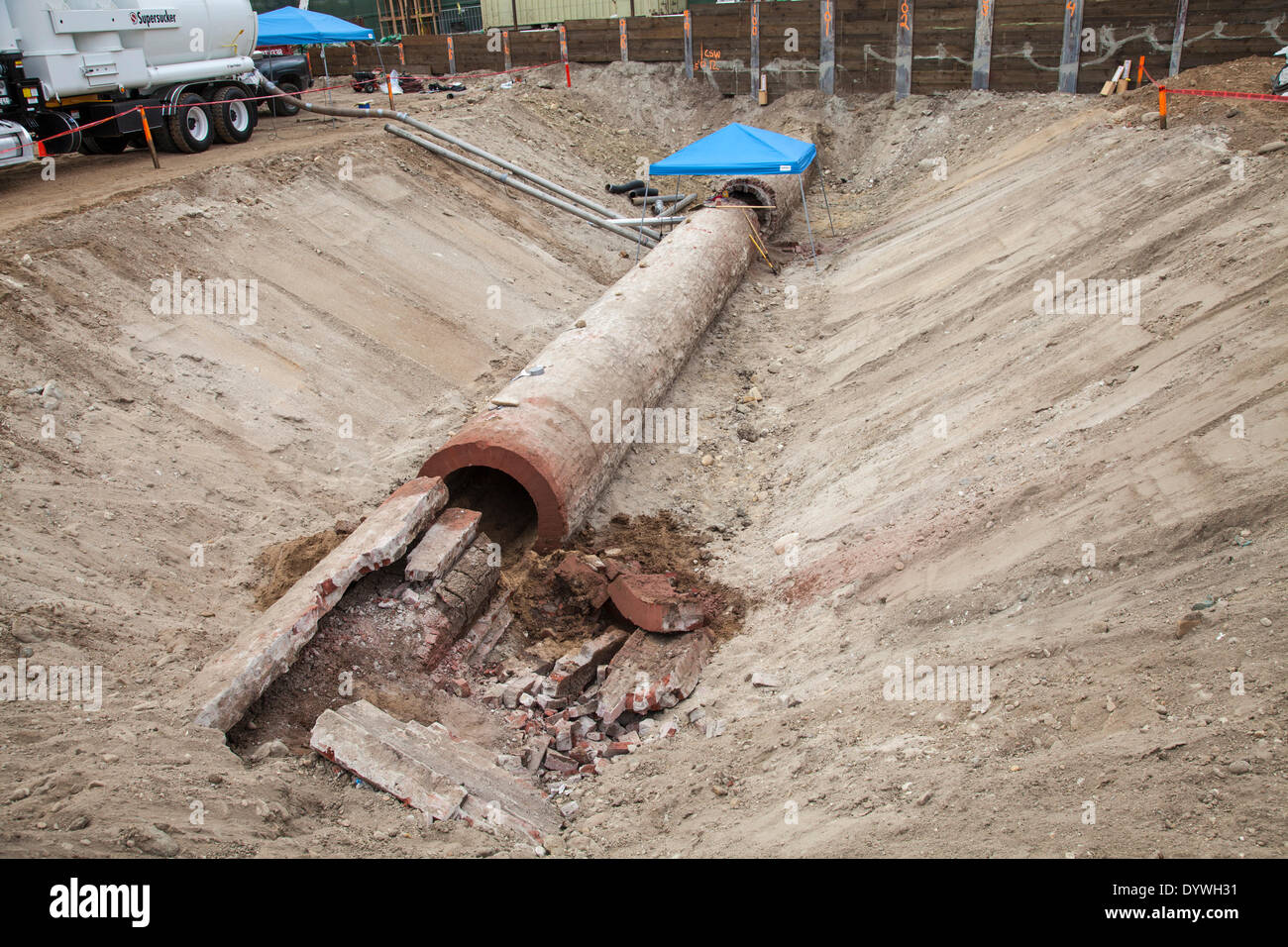 Los Angeles, CA, USA. 25th Apr, 2014. Workers clean out a section and prepare the recently unearthed Zanja Madre, or Mother Ditch, for removal to the nearby Metabolic Studios for safe keeping. The 100 foot section and 4 foot diameter of brick pipe was found at a construction site at Chinatown and is a remnant of the 90 mile network of channels that brought water to the early inhabitants of Los Angeles. Originally built in 1781 it was enclosed in 1877 and eventually abandoned in 1904. Credit:  Ambient Images Inc./Alamy Live News Stock Photo
