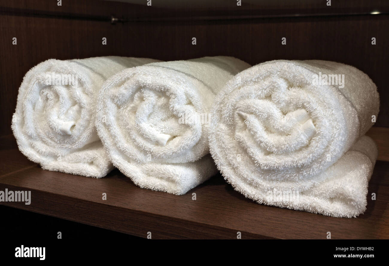 Berlin, Germany, rolled white towels in a cabinet Stock Photo