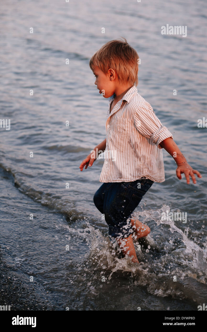 Boy playing by lake hi-res stock photography and images - Alamy