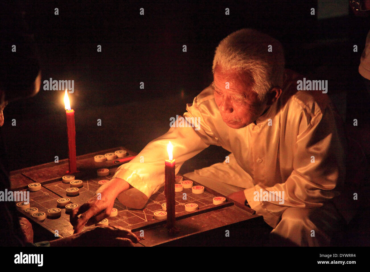 Asian old man playing Xiangqi (Chinese chess) Stock Photo