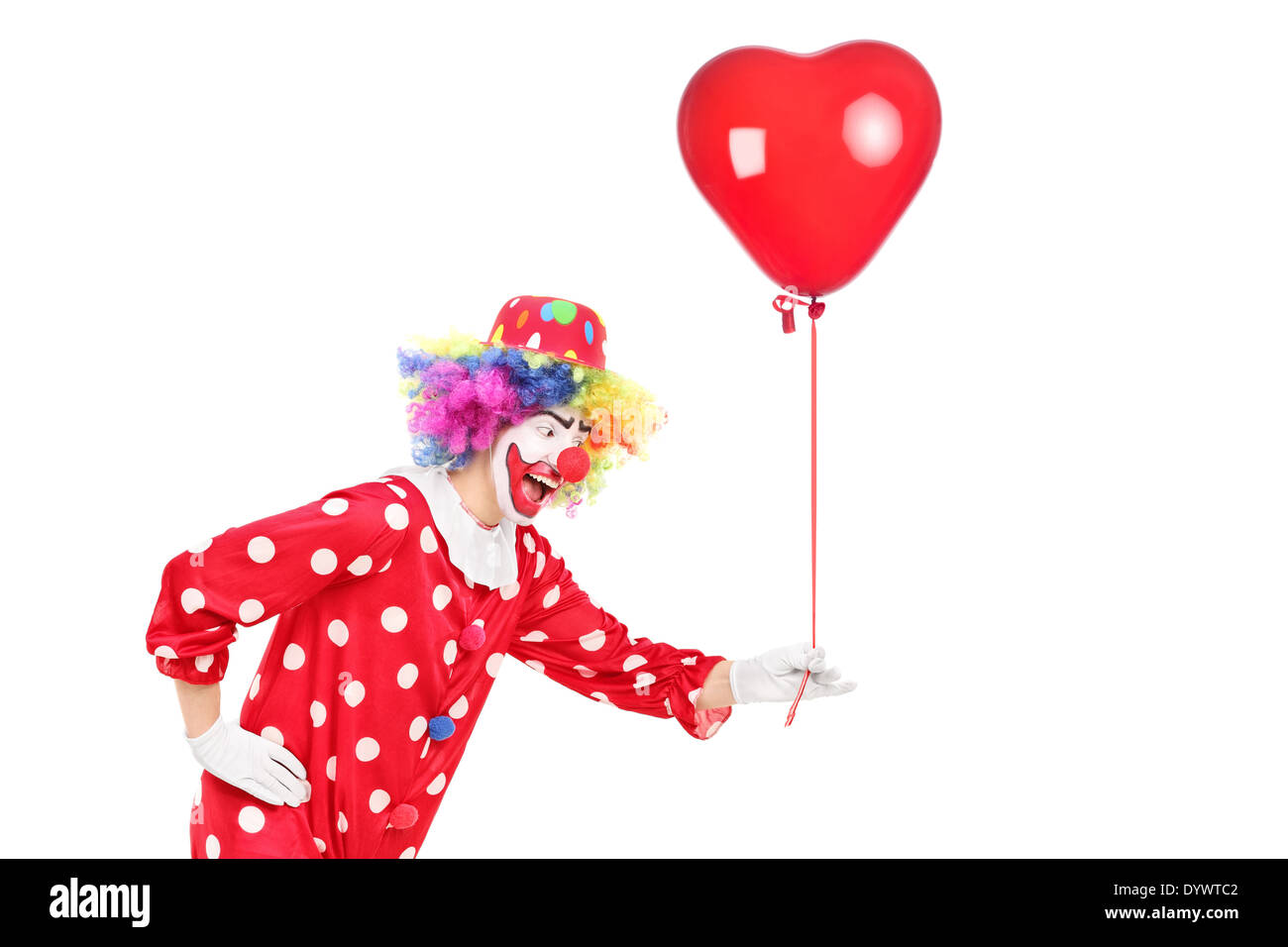 Male clown holding a red balloon Stock Photo