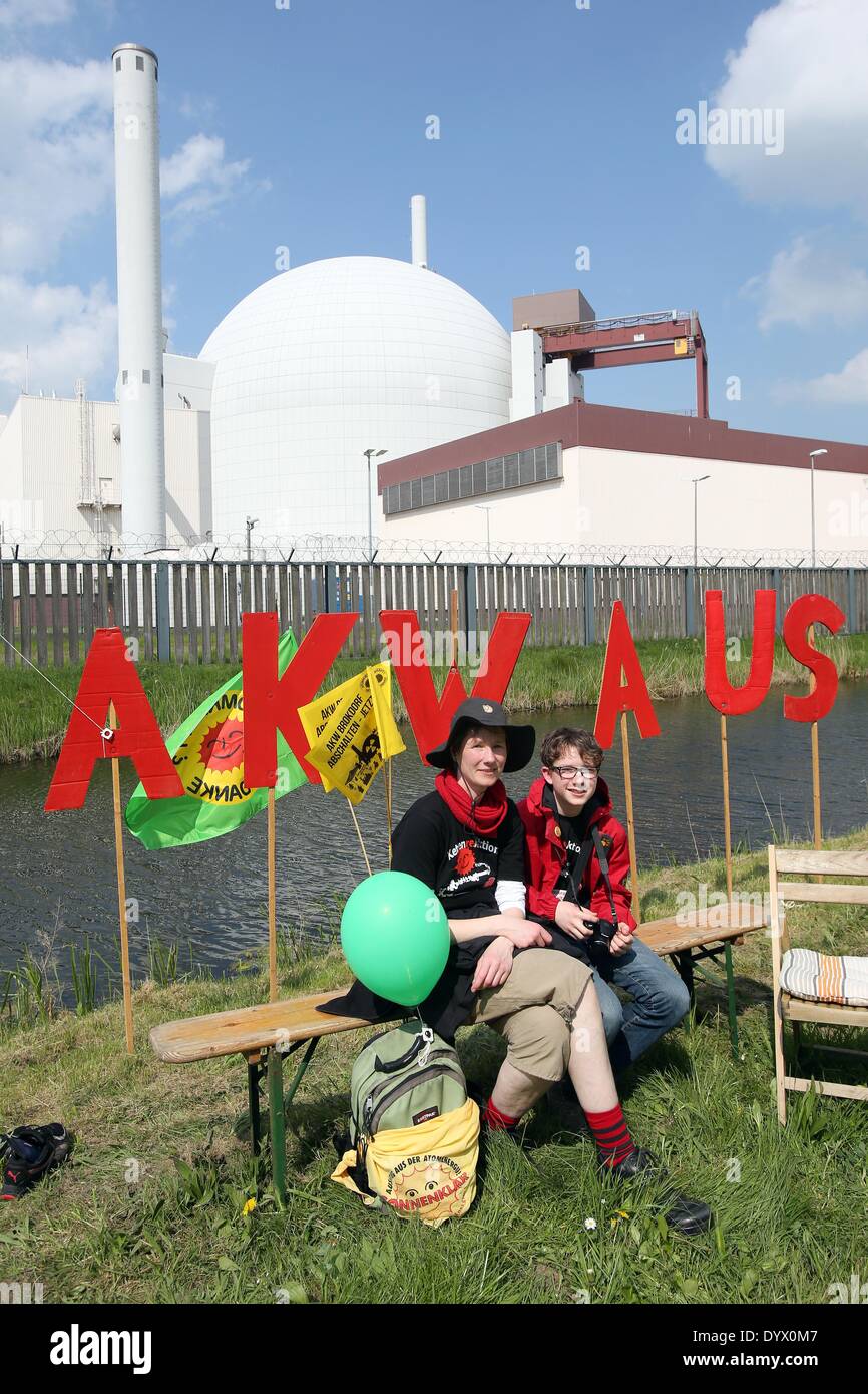Brokdorf, Germany. 26th Apr, 2014. Karen and her son Tobias sits during a demonstration outside of the nuclear power plant in Brokdorf, Germany, 26 April 2014. The demonstration was organized to mark the 28th anniversary of Chernobyl and are demanding that Brokdorf be decommissioned. Photo: BODO MARKS/dpa/Alamy Live News Stock Photo