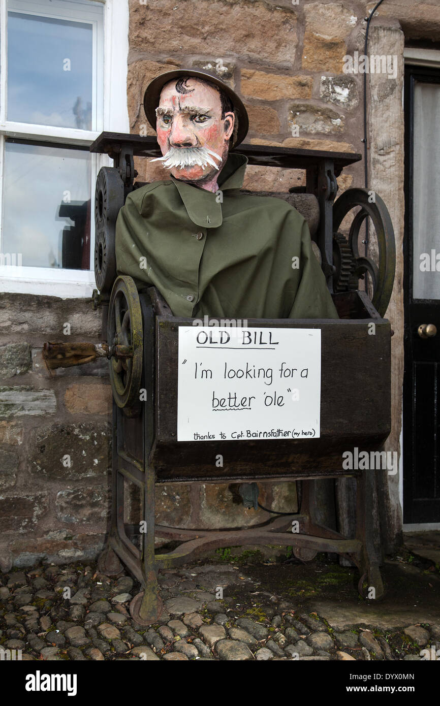 Whiskered 'Old Bill' in a mangle at the Wray Scarecrow Festival which opened on Saturday 26th April, 2014 for a series of Scarecrow parades, Old Bill is a fictional character created in 1914–15 by cartoonist Bruce Bairnsfather. Old Bill (police officer0 was depicted as an elderly, pipe-smoking British 'tommy' with a walrus moustache. The character achieved a great deal of popularity during World War I where it was considered a major morale booster for the British troops. Stock Photo