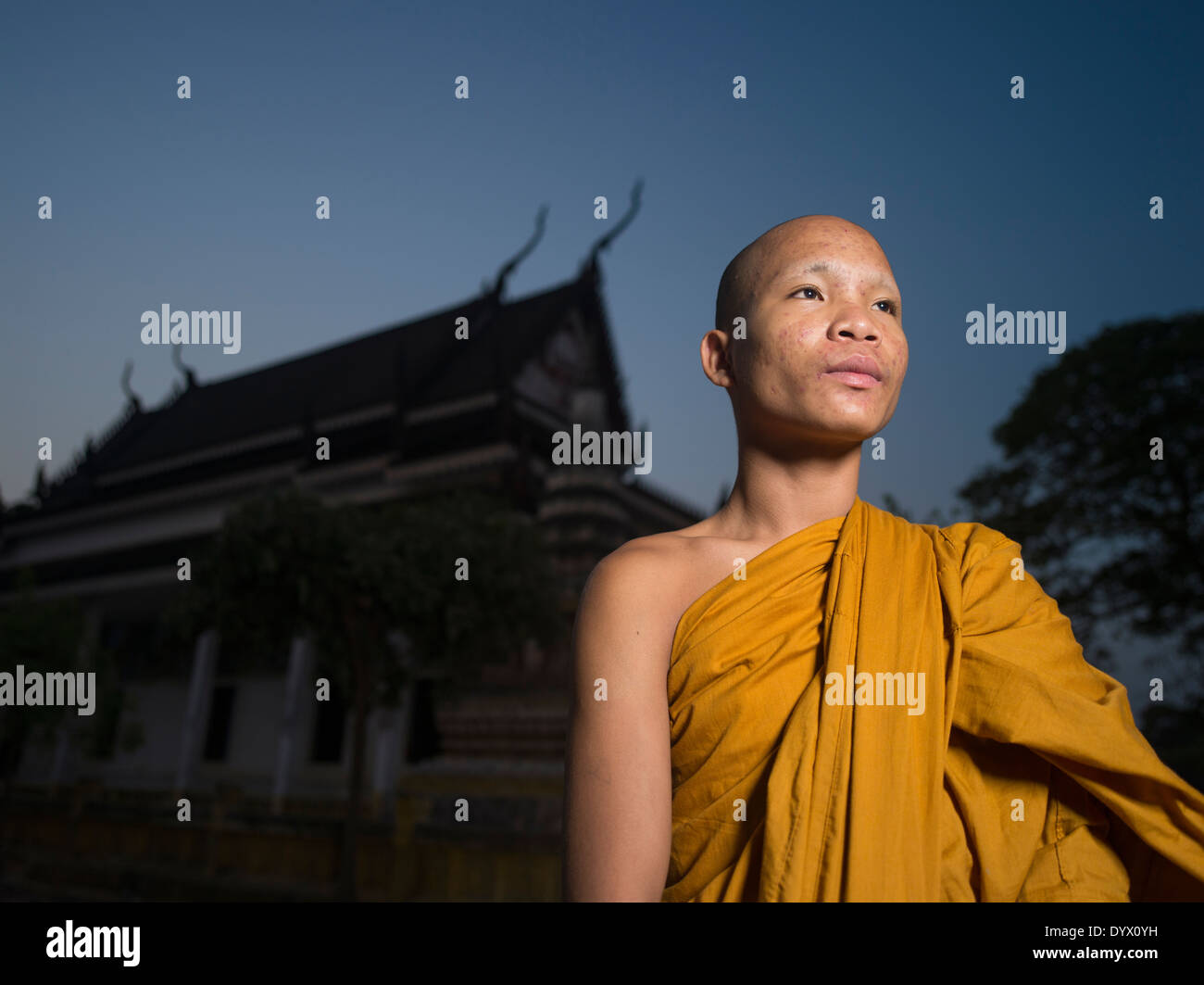 Cambodian Buddhist monk at Angkor Wat Temple at dawn, Siem Reap, Cambodia Stock Photo