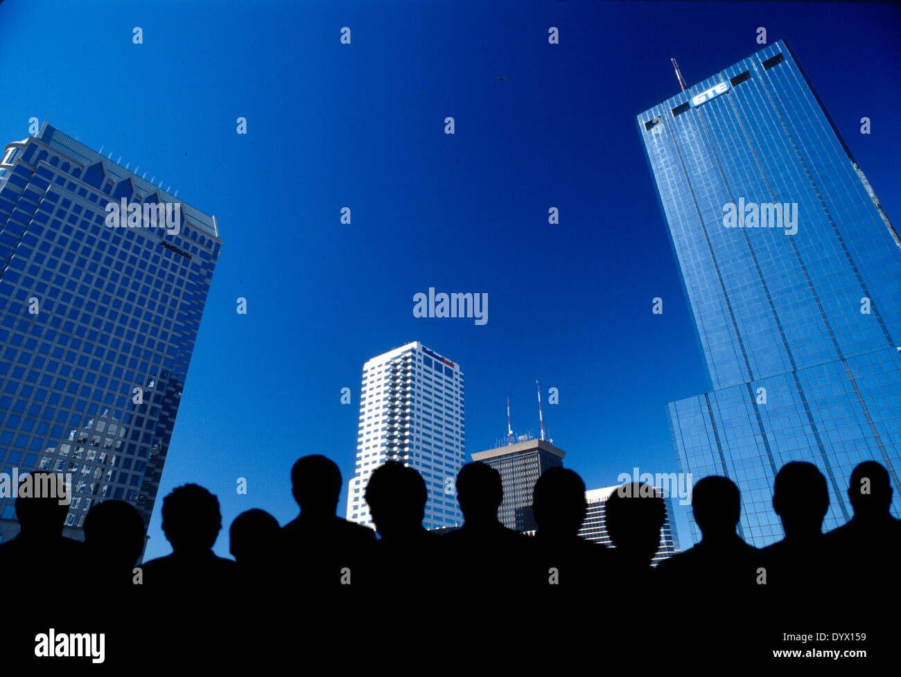 computer generated people in silhouette with city skyline Stock Photo