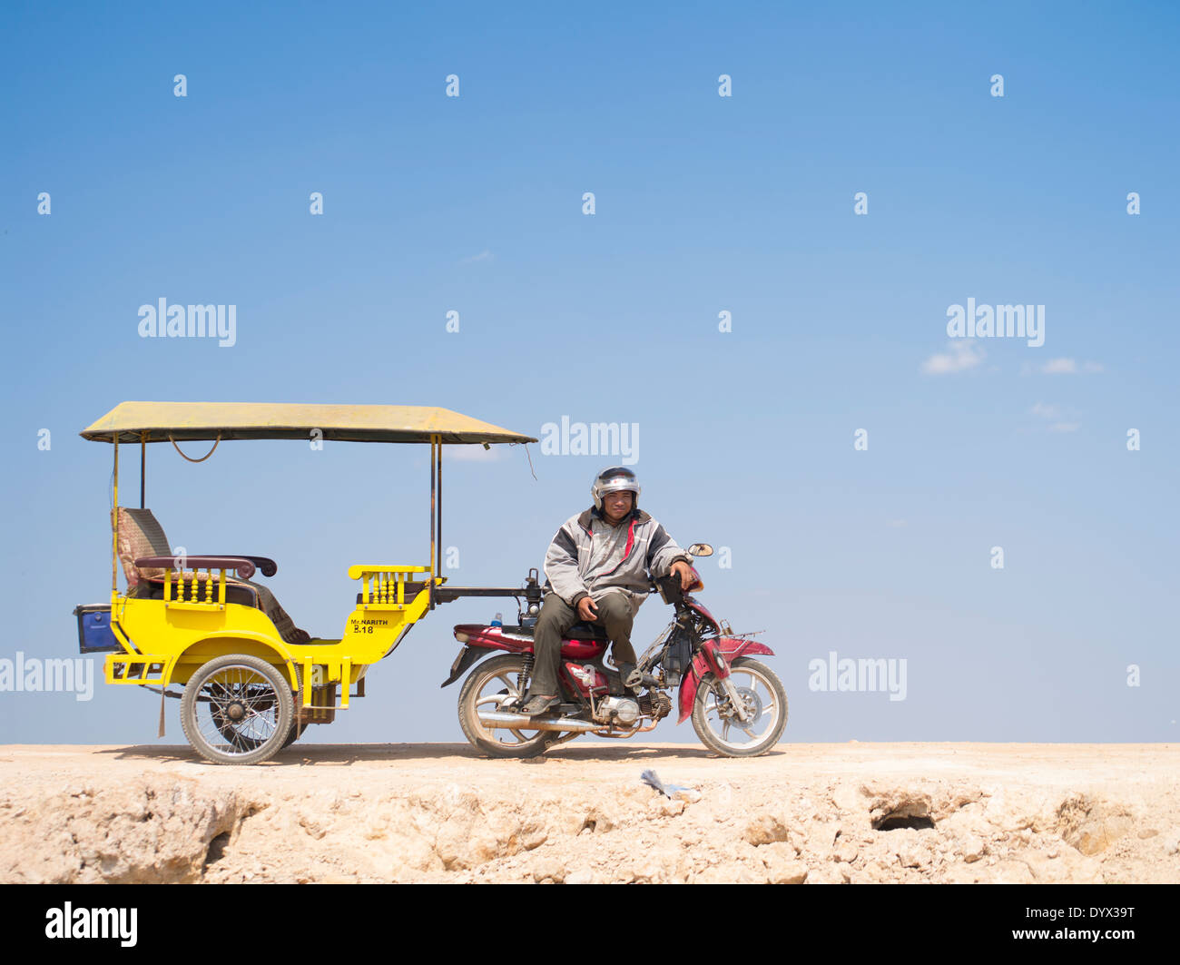 Tuk tuk driver on the road in  Siem Reap, Cambodia Stock Photo