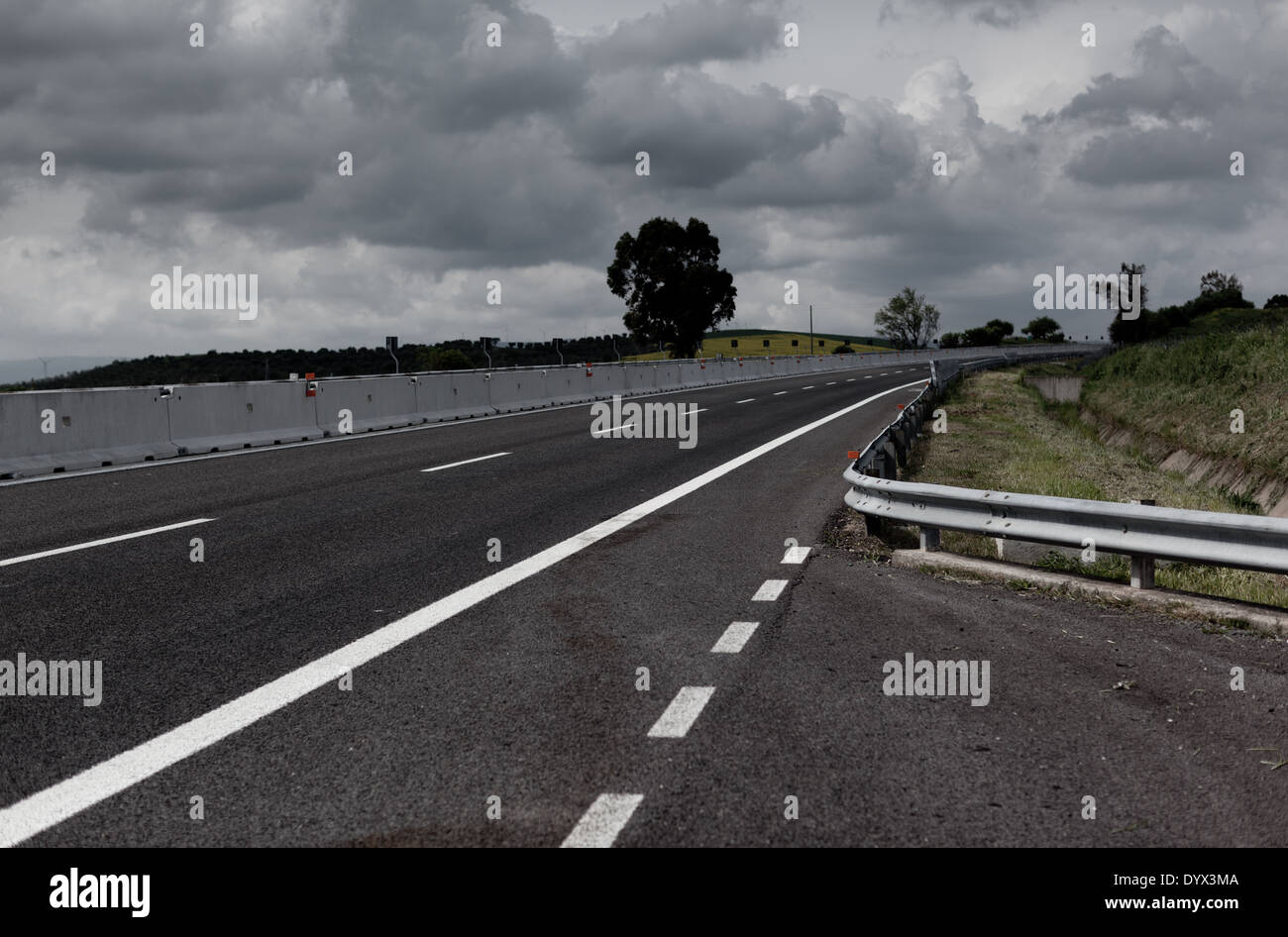 Highway under stormy sky Stock Photo - Alamy
