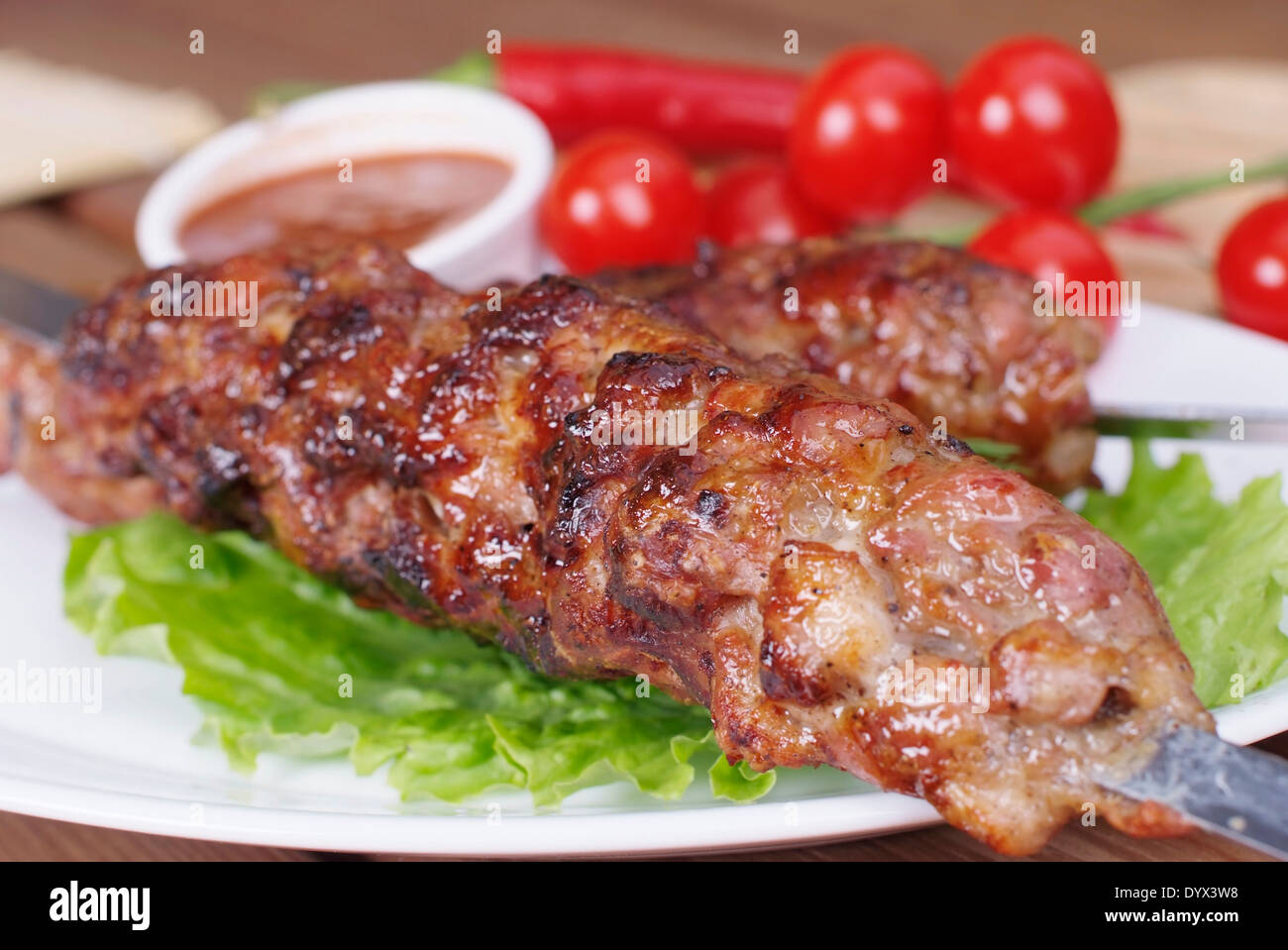 grilled meat on skewers with salad and sauce Stock Photo