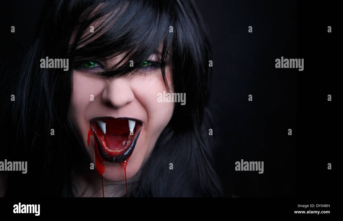 Female vampire with bloody mouth Stock Photo