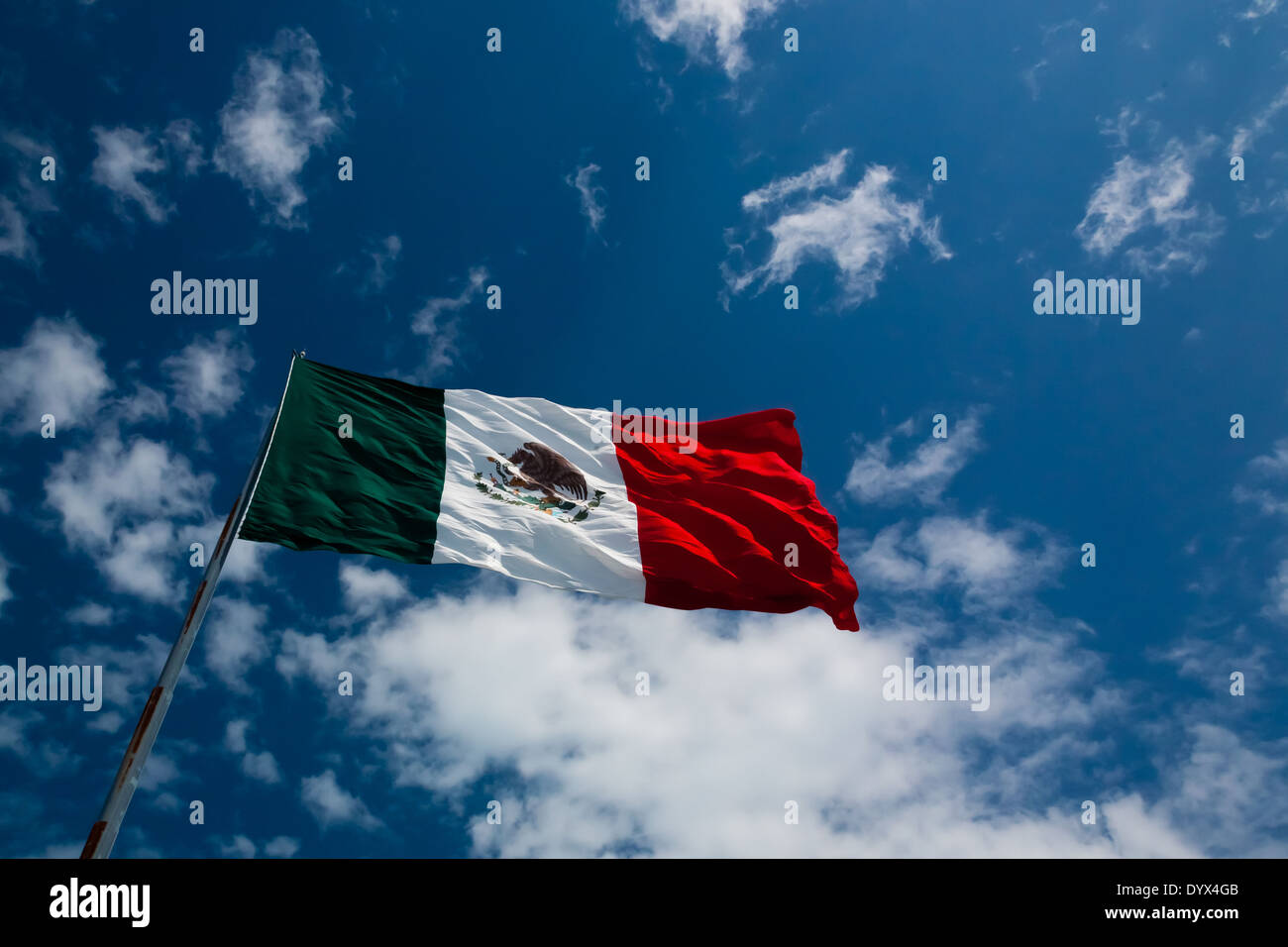 The Flag of Mexico seen from below on a rich blue sky Stock Photo