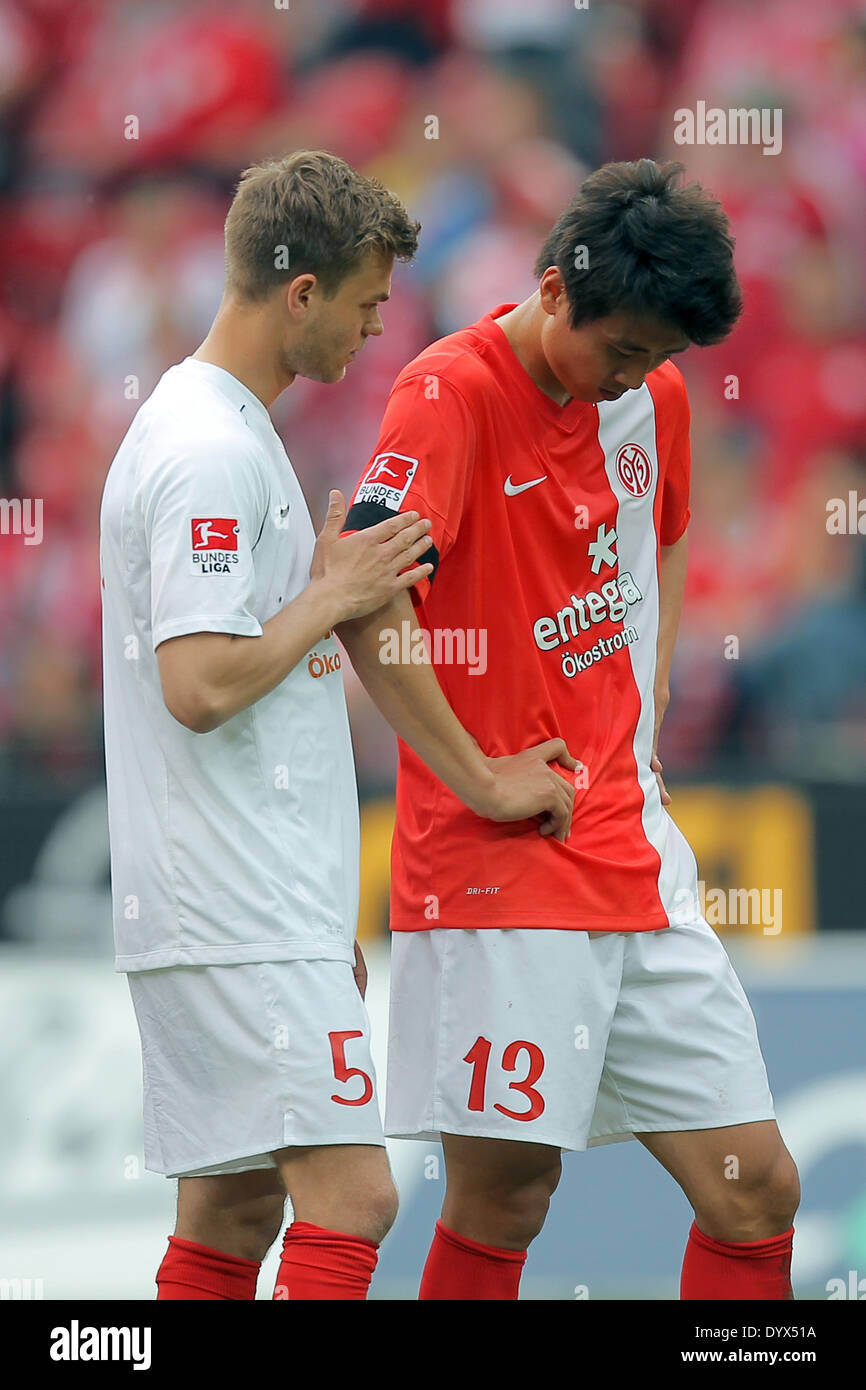 Mainz, Germany. 26th Apr, 2014. Mainz' Ja-Cheol Koo (R), who is from South Korea, looks at the black ribbon he wears to commemorate the victims of the South Korean ferry tragedy next to Benedikt Saller during the German soccer Bundesliga match between 1. FSV Mainz 05 and 1. FC Nuremberg at the Coface Arena in Mainz, Germany, 26 April 2014. Photo: FREDRIK VON ERICHSEN/dpa (ATTENTION: Due to the accreditation guidelines, the DFL only permits the publication and utilisation of up to 15 pictures per match on the internet and in online media during the match.)/dpa/Alamy Live News Stock Photo