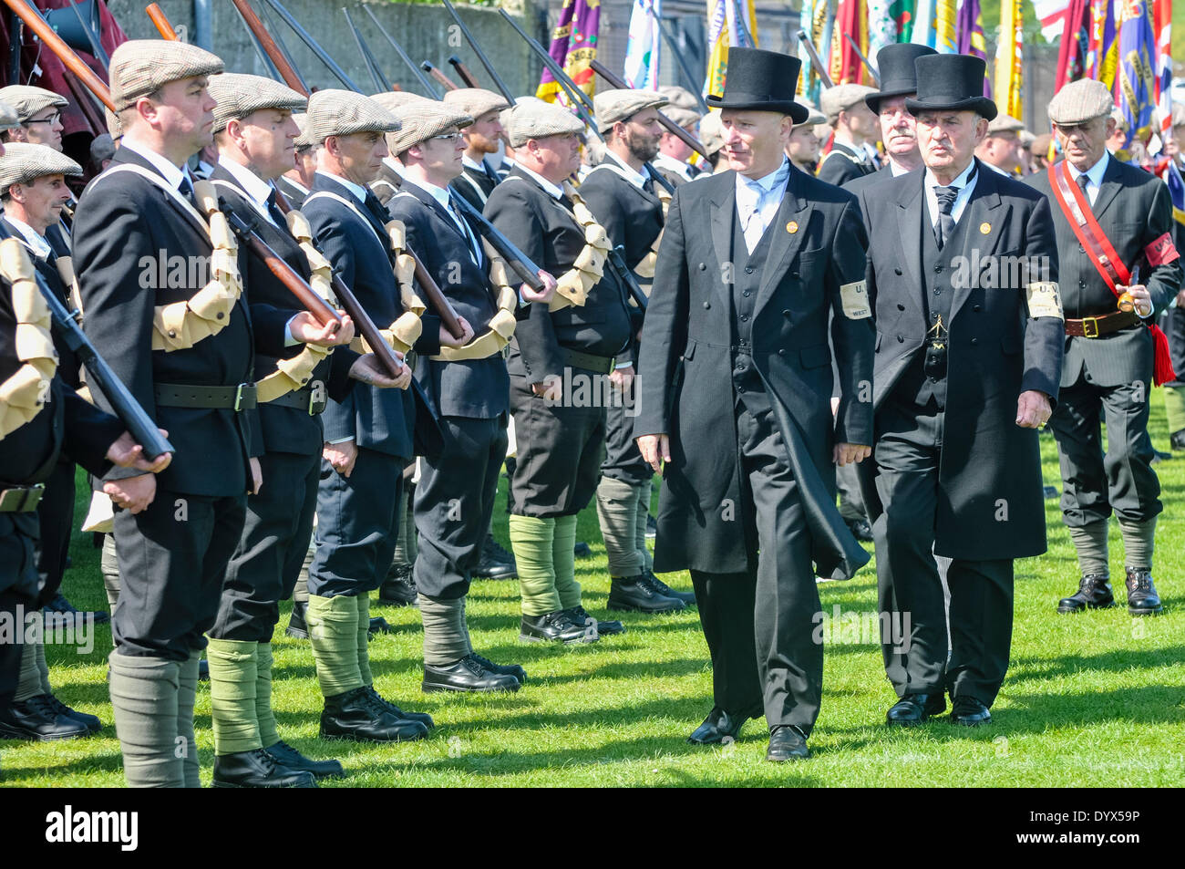 Larne, Northern Ireland. 26 Apr 2014 -  Lord Edward Carson (PUP leader Billy Hutchinson) inspects the UVF troops during a re-enactment of the 1914 Larne gun-running with Nigel Gardiner (R) and Ken Wilkinson (behind). Credit:  Stephen Barnes/Alamy Live News Stock Photo