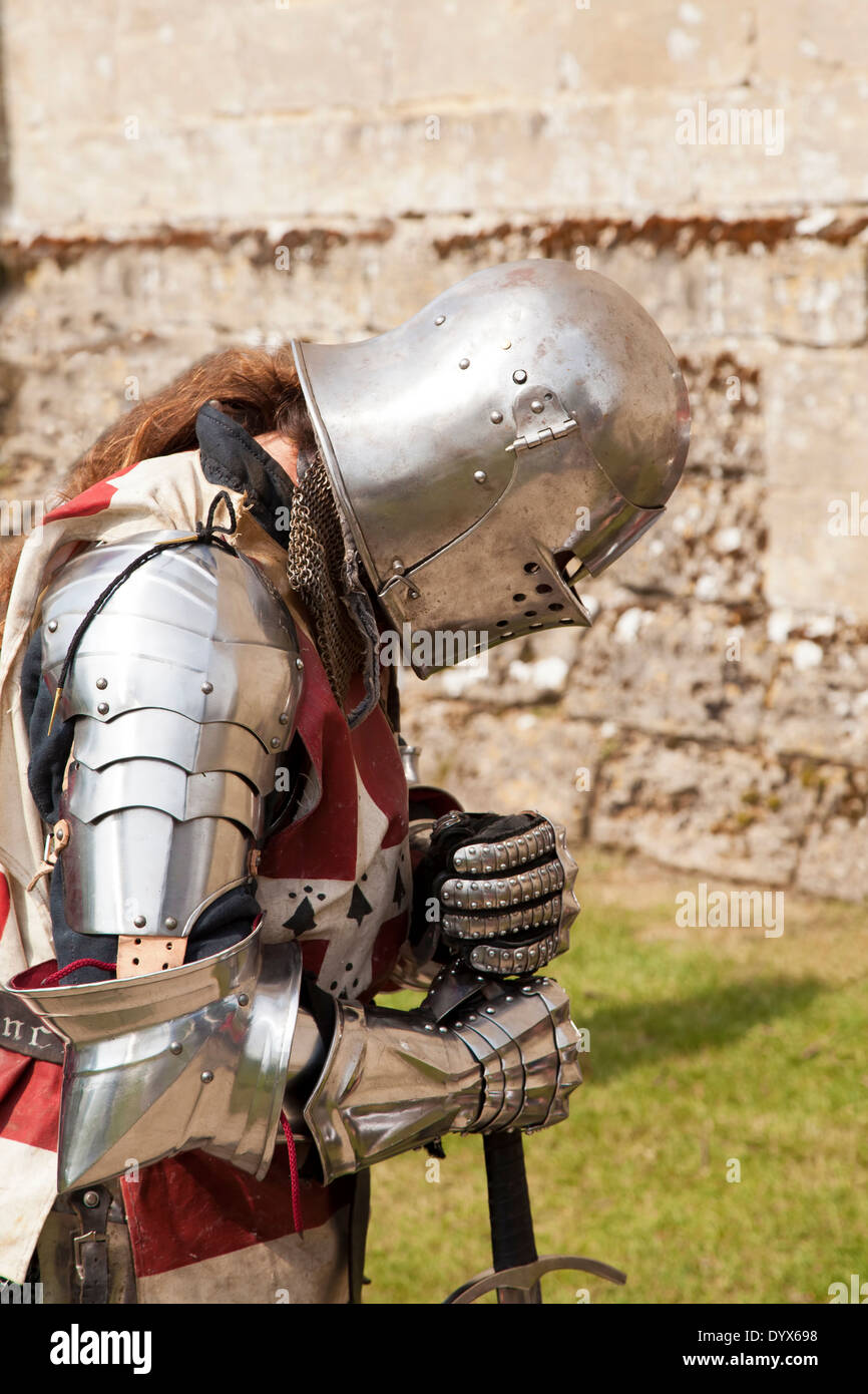 Knight in armour bowing Stock Photo