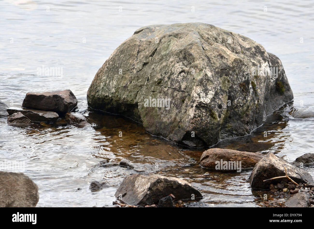 Rocks at the waters edge on Loch Lomond in Scotland Stock Photo