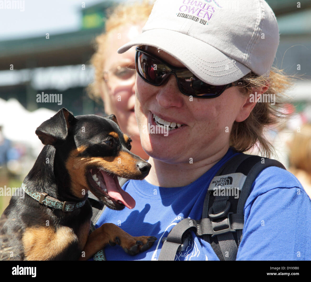 Lexington, Ky, US. 26th Apr, 2014. Jodie Dickey of Lexington with her dog, Minnesota watched the action at the Head of the Lake during the cross country competition of the 2014 Rolex Kentucky Three-Day Event at the Kentucky Horse Park in Lexington, Ky., on April 26, 2014. Bay My Hero with William Fox-Pitt were in the lead after the cross country event. Photo by Pablo Alcala | Staff © Lexington Herald-Leader/ZUMAPRESS.com/Alamy Live News Stock Photo