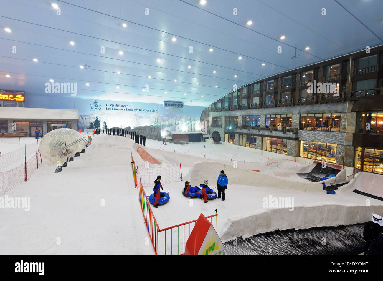 Children playing on snow in the indoor Ski Dubai resort in the Mall of