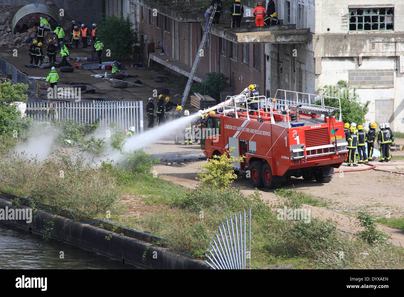 London, UK. 26th Apr, 2014. Saturday saw Firefighters were amongst over 220 emergency services personnel taking part in a large exercise in East London. The simulated crash of a Boeing 737 into a building, provided rescuers with over 100 casualties to rescue. A number of casualties were plucked from water by rescue boats. The exercise is due to last three days. Credit:  HOT SHOTS/Alamy Live News Stock Photo