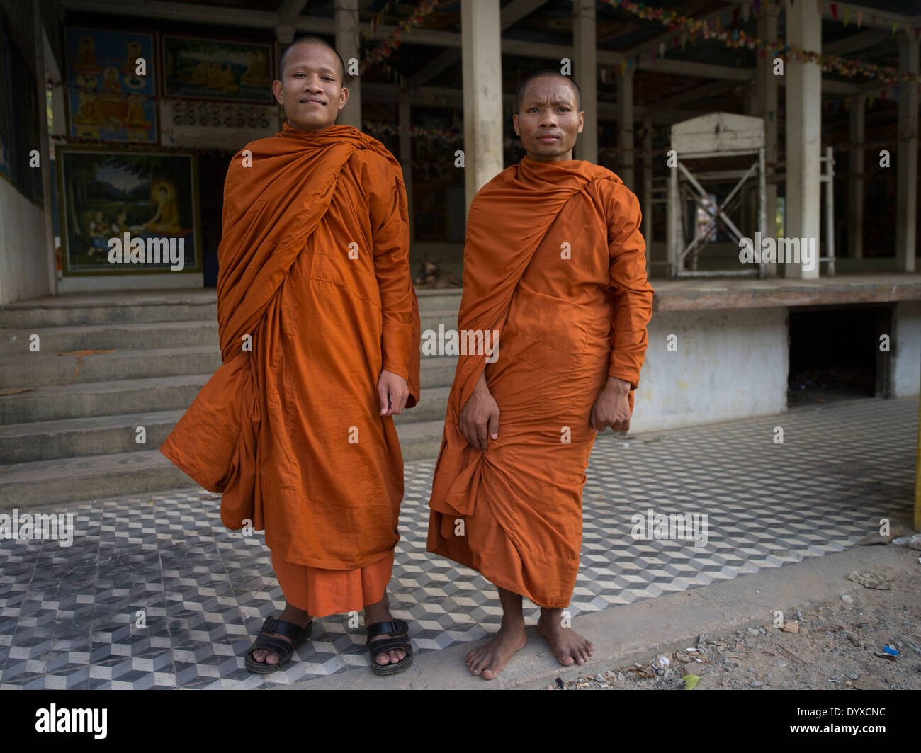 Buddhist monks in traditional orange robes at Angkor Wat, Siem Reap, Cambodia Stock Photo