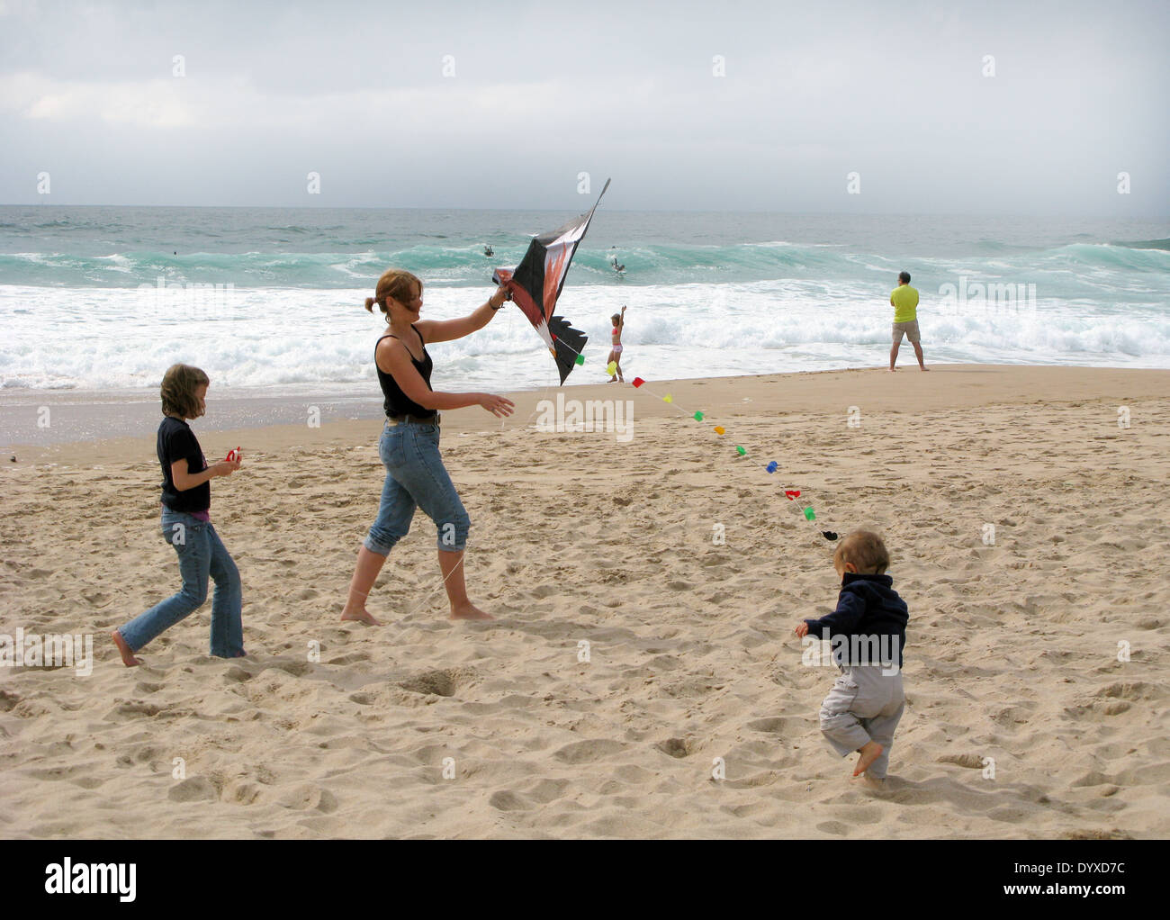 A Family Enjoying Their Vacation At The Guincho Beach In
