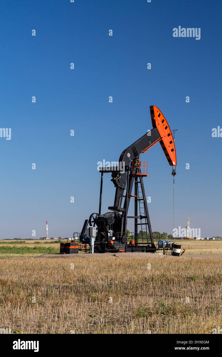 An oil production pumper in the Bakken field near Stoughton, Saskatchewan, Canada. Stock Photo