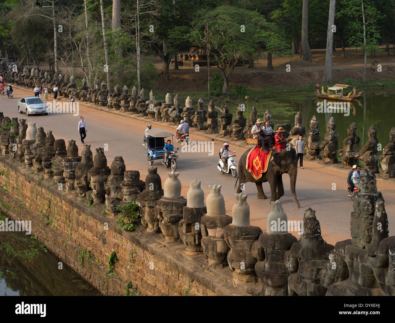 Tourists riding on an elephant approach the South Gate of Angkor Thom, Siem Reap, Cambodia Stock Photo